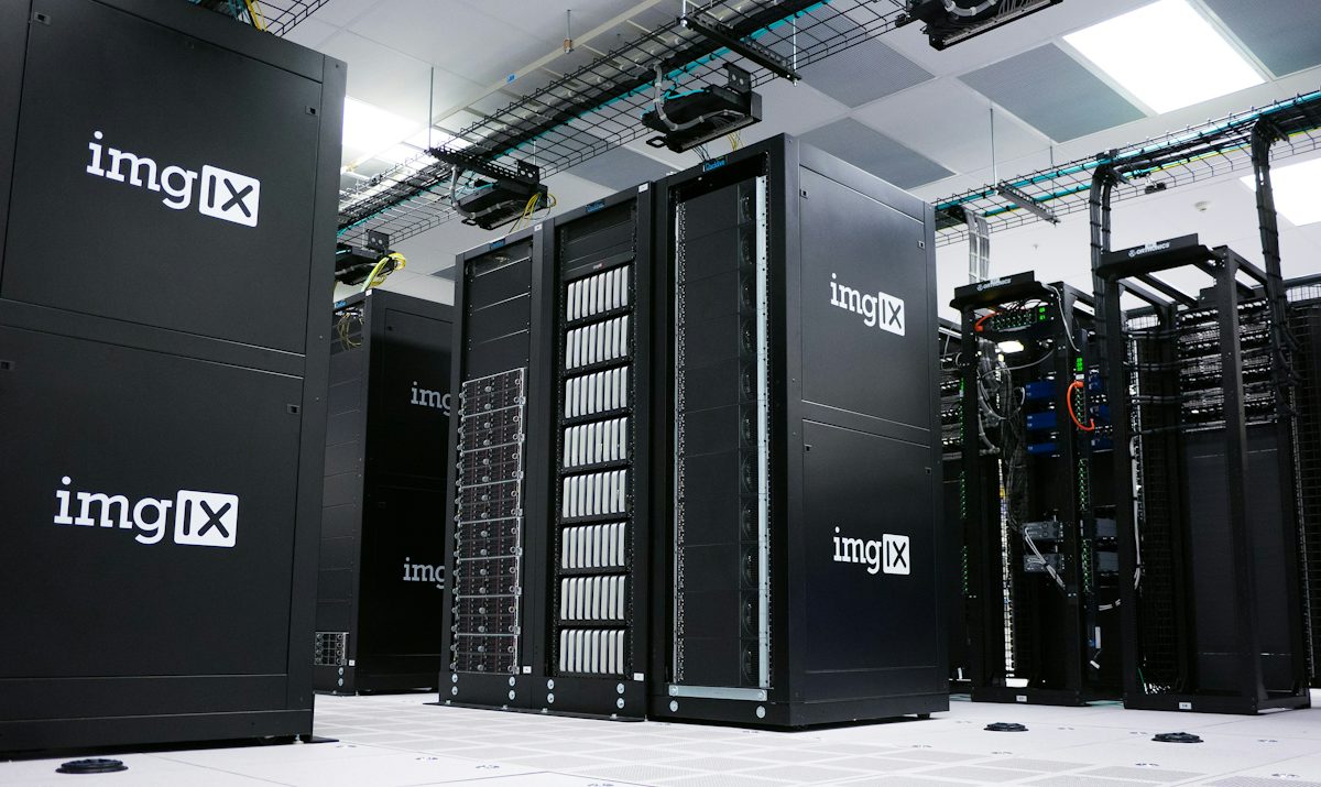 Rows of black server racks with white logos in a data center